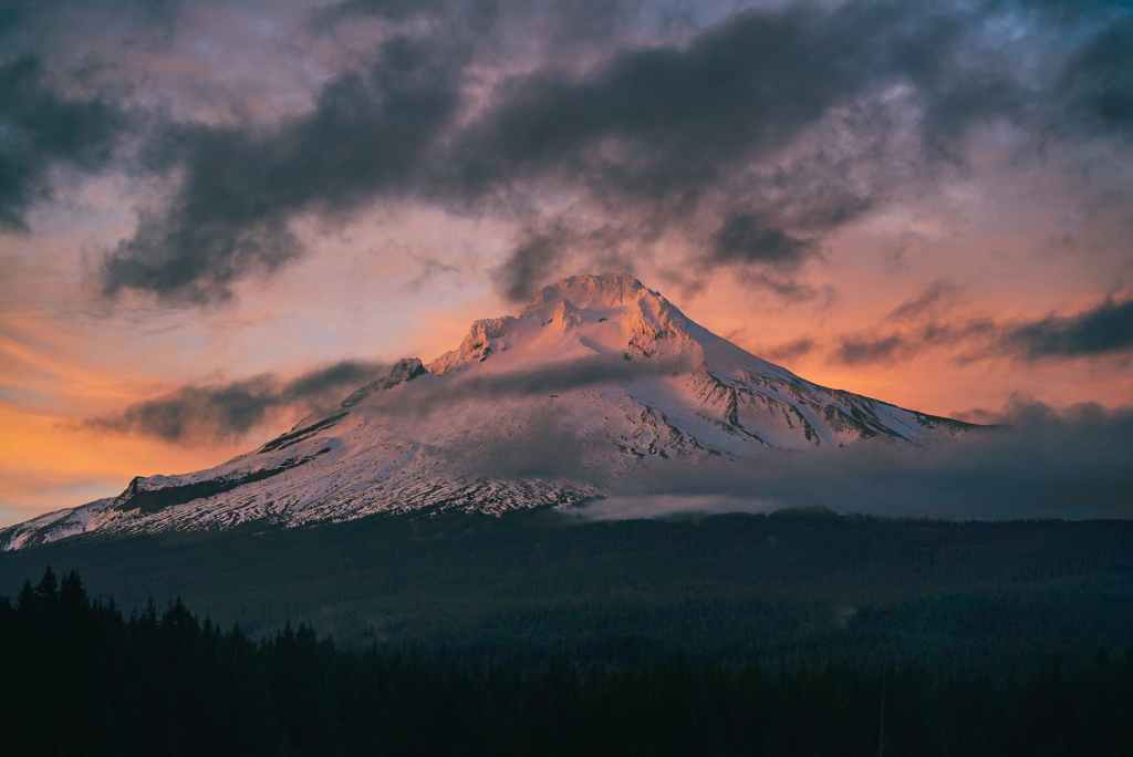 white and brown mountain under gray clouds